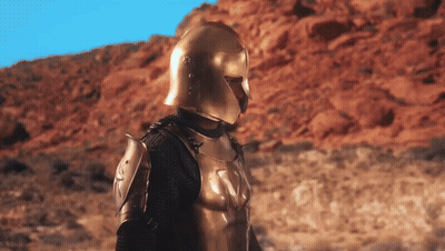Armored Man With Gold Helmet In Desert GIF