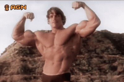Arnold Schwarzenegger Flexing Muscles In Front Of AGN Sign GIF