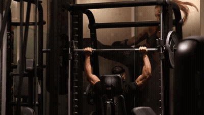 Arnold Schwarzenegger Flexing Muscles Looking At Camera GIF