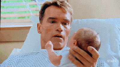 Arnold Schwarzenegger Holding Baby In Hospital Bed With Starz GIF
