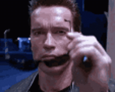 Arnold Schwarzenegger Holding Sunglasses In Mouth GIF