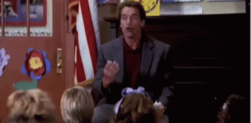 Arnold Schwarzenegger Is Giving A Speech To A Group Of Children In A Classroom . GIF