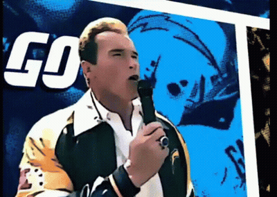 Arnold Schwarzenegger Singing Into Microphone In Front Of Go On It Sign GIF