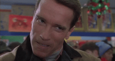 Arnold Schwarzenegger Smiling In Suit And Tie GIF