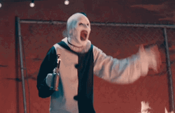 Art The Clown Holding Mini Fire Torch GIF