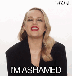 Ashamed Blonde Girl With Red Lips GIF