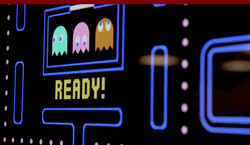Asian Guy Playing Pac Man On Big Screen GIF