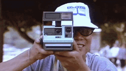 Asian Tourist Using Polaroid Camera