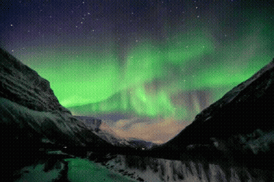 Aurora Borealis Over Snowy Mountains GIF