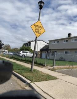 Autism Mocking Kid Dancing Under Autistic Sign GIF