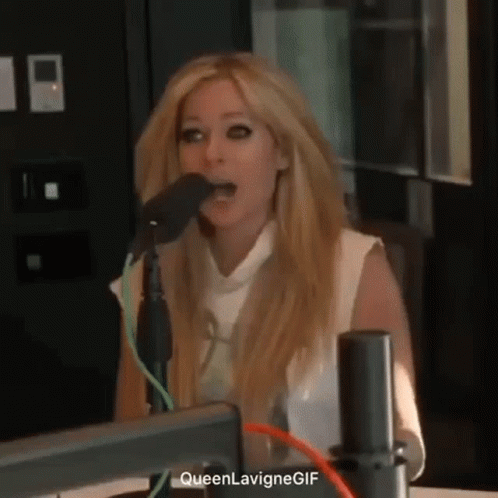 Avril Lavigne Is Singing Into A Microphone In A Radio Studio . GIF