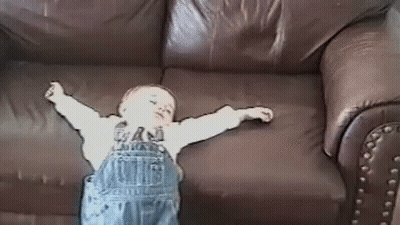Baby Arms Outstretched On Brown Leather Couch GIF