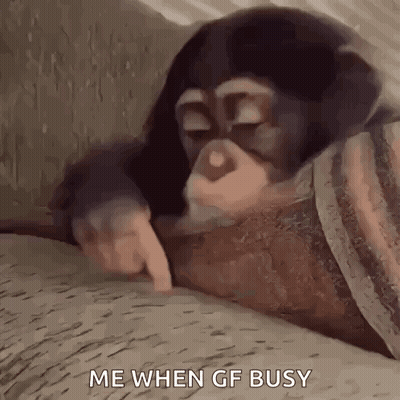 Baby Chimpanzee Lying on Couch Pointing