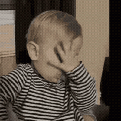 Baby Covering Face in Striped Shirt