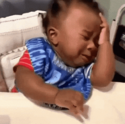 Baby Crying In Crib Holding Head GIF