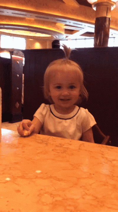 Baby Crying In Crowd Held By Woman GIF