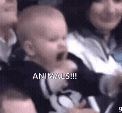 Baby Crying In Crowd Held By Woman GIF