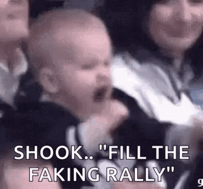 Baby Crying In Crowd Held By Woman GIF