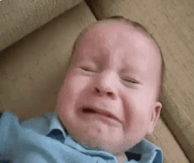 Baby Crying on Couch With Eyes Closed