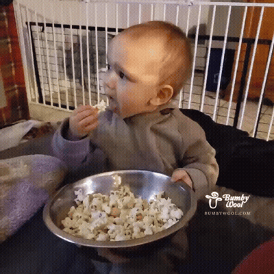 Baby Eating Popcorn From Bowl Saying Bumpy Woof GIF