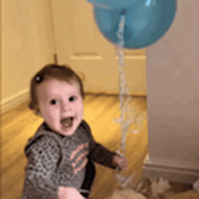 Baby Girl Holding Blue Balloon GIF