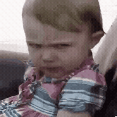 Baby Girl In Car Seat Making Funny Face GIF