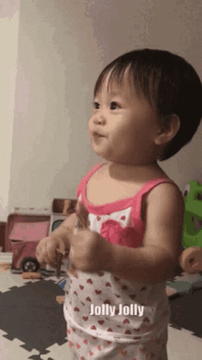 Baby Girl In Pink Tank Top Saying Jolly Jolly GIF
