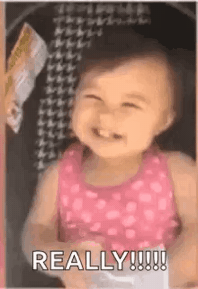 Baby Girl In Pink Tank Top Smiling GIF