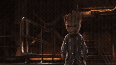 Baby Groot In Pajamas Standing In Dark Room GIF