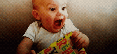 Baby Holding Birthday Wrapping Paper Mouth Open GIF
