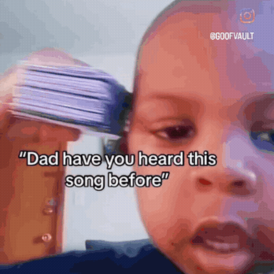 Baby Holding Cards To Ear Says Dad Have You Heard This Song Before GIF