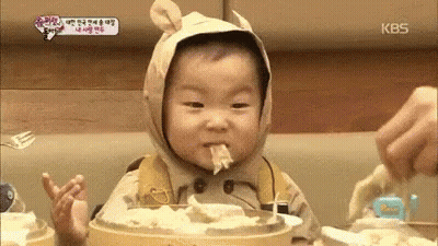 Baby In Bear Costume Eating Noodles GIF