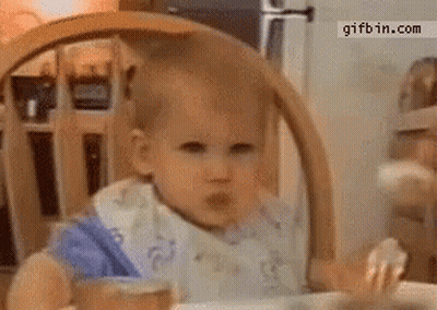 Baby In Bib Eating In High Chair GIF