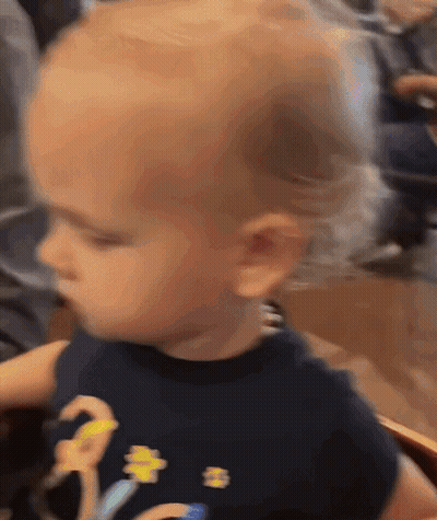 Baby In Black Shirt With Yellow Flower GIF