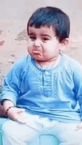 Baby In Blue Shirt Making Funny Face On Chair GIF