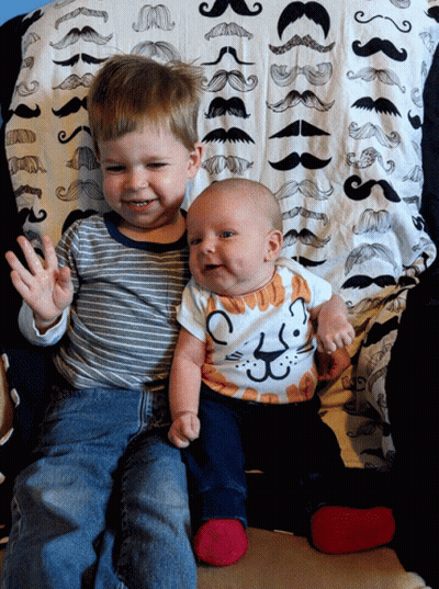 Baby in Cat Shirt Next to Boy