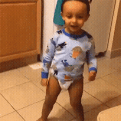 Baby In Diaper Standing On Tiled Floor GIF
