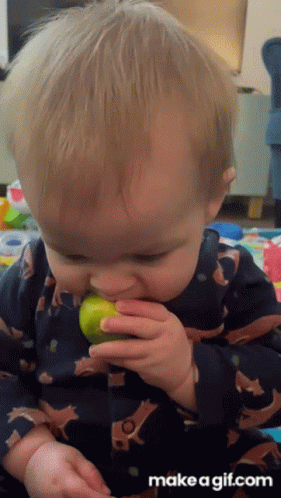 Baby In Fox Print Pajama Eating Lemon GIF