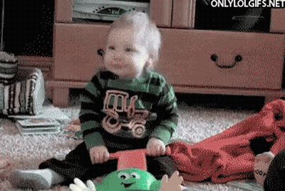 Baby In Green And Black Striped Shirt With Truck GIF