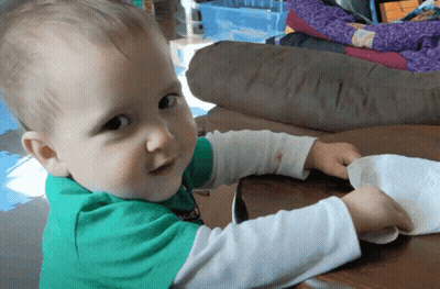 Baby In Green Soccer Shirt Playing With Paper Towel GIF