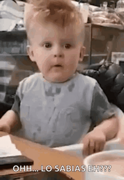 Baby In High Chair Making Funny Face GIF