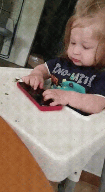 Baby In High Chair Playing With Phone Wearing No-Limit Shirt GIF