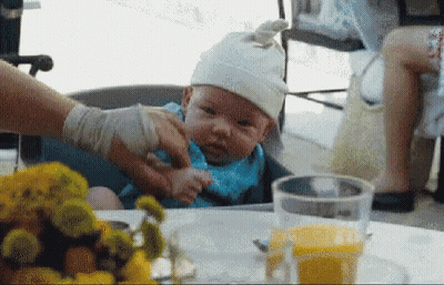 Baby In High Chair Wearing White Hat GIF