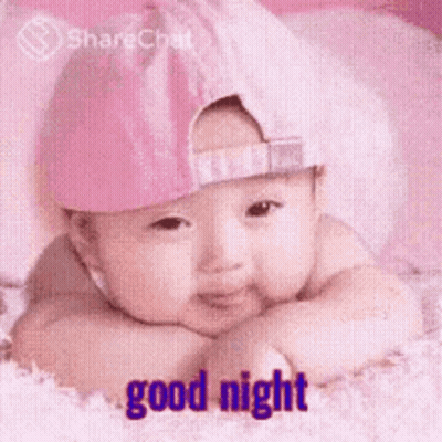 Baby In Pink Hat Laying On Bed Good Night GIF