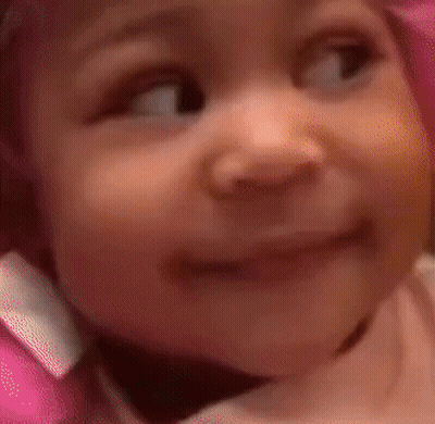 Baby In Pink Hat Making Funny Face GIF
