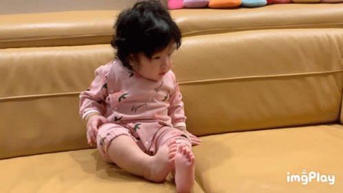 Baby In Pink Outfit Sitting On Couch With Imgplay GIF