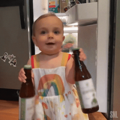 Baby In Rainbow Dress Holding Two Bottles SNL GIF