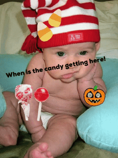 Baby In Red And White Striped Hat With Candy Corn GIF