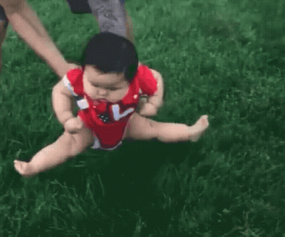 Baby In Red Bodysuit Being Held GIF