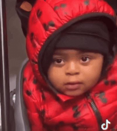 Baby In Red Jacket And Black Hat In Stroller GIF